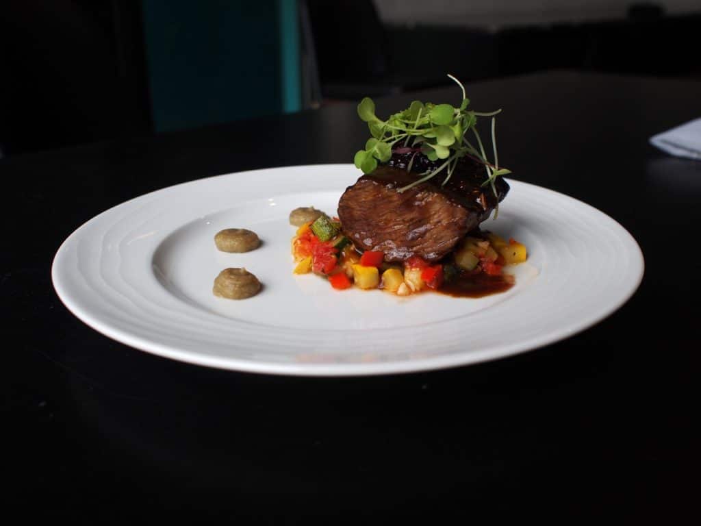 Carolina Bison Shoulder Braised in Green Man Porter served over a ratatouille of summer sqashes, with roasted Garlic eggplant puree and Appalachian Blackberries